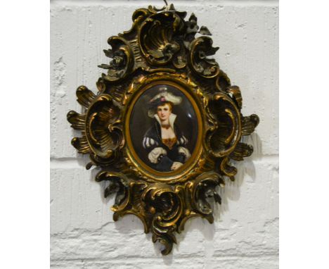 Berlin porcelain plaque, oval, painted with a portrait of a young lady, gesso scrolled frame, height overall 36cms.