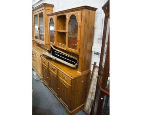 Modern Ducal pine dresser, moulded cornice, the upper section with glazed doors and a shelf, the base with a rectangular top,