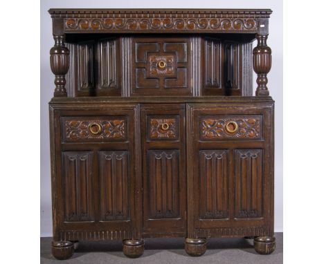 Oak court cupboard, rectangular top with a moulded edge, carved frieze, the upper section with a cupboard, turned and fluted 