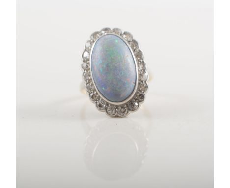 Lady's opal and diamond cluster ring, oval cabochon cut opal 15.5mm x 9.5mm, collet set and surrounded by diamonds (20), old 