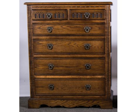 Reproduction oak chest of drawers, rectangular top, with a moulded edge, two short carved drawers above four long graduating 