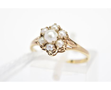 A 9CT GOLD SPLIT PEARL CLUSTER RING, designed as a tiered cluster of claw set split pearls to the bifurcated shoulders, with 