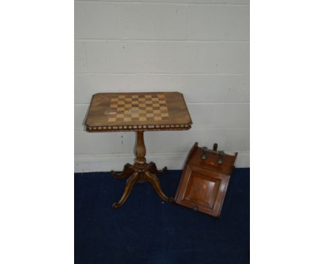 A VICTORIAN ROSEWOOD RECTANGULAR GAMES TOPPED TRIPOD TABLE on a scrolled base (some losses to canted corner, little veneer lo