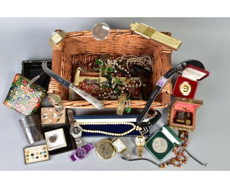 A BASKET OF MISCELLANEOUS ITEMS, to include two gem necklaces, fossil pendant, a silver handled cheese knife, two cased coins