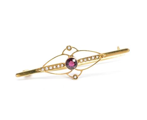 AN EARLY 20TH CENTURY 9CT GOLD GARNET AND SPLIT PEARL BROOCH, of elongated design, the central circular garnet within a mille