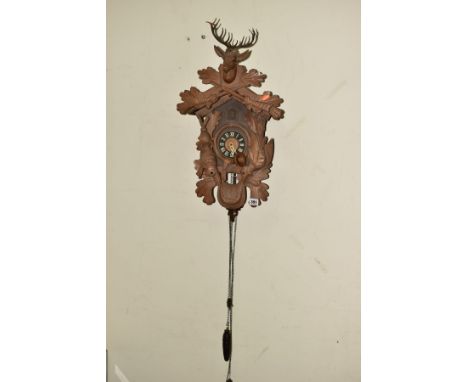 A 20TH CENTURY BLACK FOREST CUCKOO CLOCK, Stag's head pediment 1008, plastic dial with Roman numerals, wooden pendulum, with 