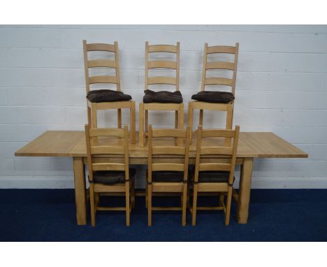 A MODERN BEECH REFECTORY TABLE with two additional leaves on four chamfered legs united by a single stretcher, extended lengt