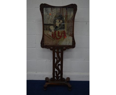 A VICTORIAN ROSEWOOD NEEDLEWORK FIRESCREEN, of a seated lady reading within a foliate scrolled frame on a pierced fretwork st