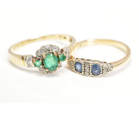 TWO GEM SET RINGS, the first designed with a central oval emerald flanked by circular emeralds in a single cut diamond surrou