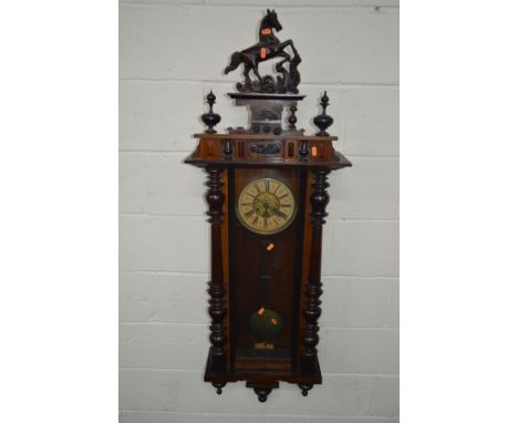 A LATE 19TH CENTURY MAHOGANY AND WALNUT VIENNA REGULATOR WALL CLOCK, with a ceramic horse pediment, the 6 1/2'' circular dial