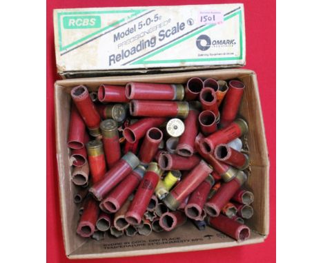 A box of empty shotgun cartridges including 8 bore primed cases with a set of R.C.B.S. reloading scales (boxed), this item ca