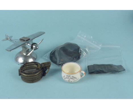 A mixed lot including a U.S.A. novelty lighter in the form of a plane, a military style marching compass and a WWII era novel