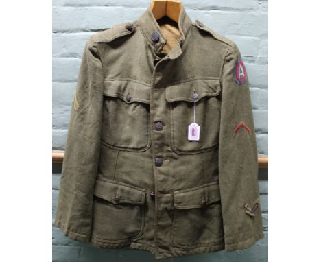 A WWI U.S. Army uniform (tunic and breeches), tunic with Lance Corporal stripe and other insignia relating to overseas servic