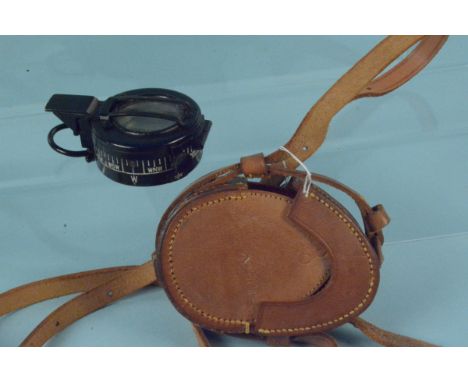 A WWII marching compass dated 1941 MkIII with leather case dated 1940