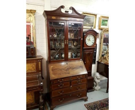 A GEORGE III PERIOD MAHOGANY BUREAU BOOKCASE, the swan neck pediment above an inlaid frieze with shells and patriae and two a