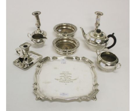 A SILVER PLATED PRESENTATION TRAY, in George II style; a pair of dwarf silver plated candlesticks; a pair of silver plated co