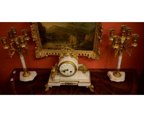 A LATE 19TH CENTURY THREE-PIECE FRENCH WHITE MARBLE AND GILT METAL MANTEL CLOCK GARNITURE, comprising a clock with floral cre