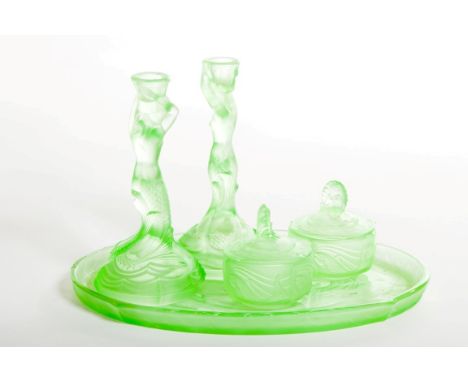 A FIVE-PIECE FRENCH GREEN GLASS DRESSING TABLE SET, in the manor of R. Lalique, comprising a pair of mermaid form candlestick
