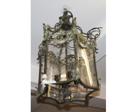 A VERY ATTRACTIVE LARGE HEXAGONAL BRASS HALL LANTERN, with six concave glass panels, and leaf-cast corona, with rococo style 