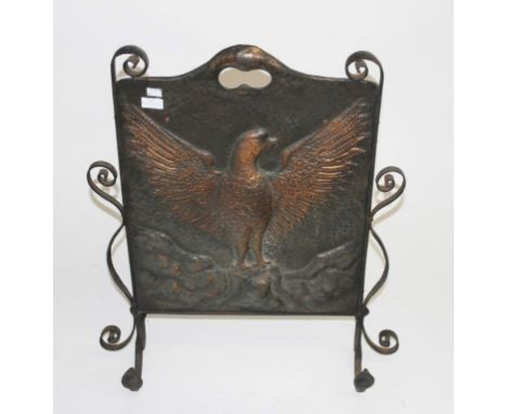 AN ARTS AND CRAFTS EMBOSSED AND WROUGHT IRON FIRE SCREEN, modelled with an eagle with outstretched wings, 29" (75cm)h x 24" (