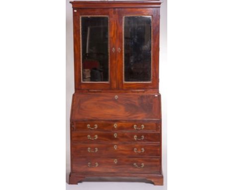 A FINE EIGHTEENTH CENTURY MAHOGANY AND PARCEL GILT BUREAU CABINET, the plain moulded cornice above two bevelled mirror panel 