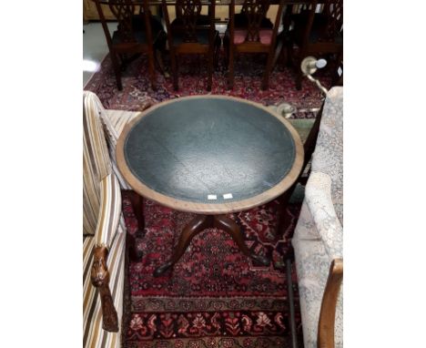 A GEORGIAN PERIOD CIRCULAR MAHOGANY FLIP-TOP CENTRE TABLE, now with tooled leather surface on an upward tapering turned stem 