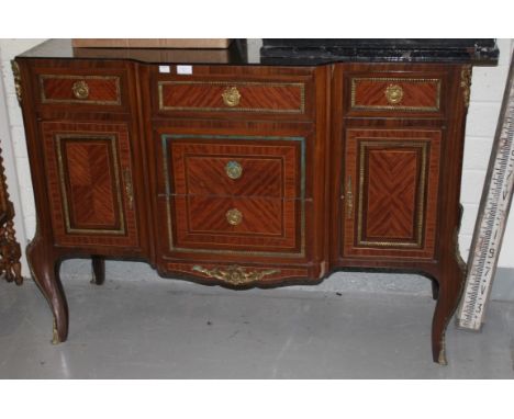 A BRASS-MOUNTED KINGWOOD COMMODE, in the transitional style with breakfront and ornate brass mounts, raised on cabriole legs,