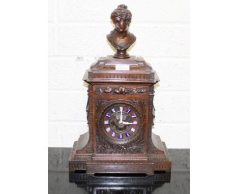 A CARVED FRENCH WALNUT-CASED BRACKET CLOCK, late 19th century, the architectural style case surmounted with a female bust and