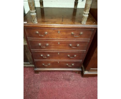 A GEORGIAN MAHOGANY NIGHT-TIME COMMODE, in the form of a chest with four mock drawers, the top lifting to reveal a seat, unfu