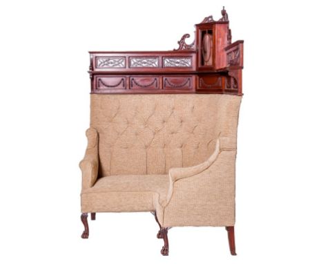 AN EDWARDIAN MAHOGANY CORNER CLUB SETTEE, the back inset with a small display cabinet, flanked with shelves to either side an