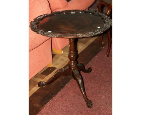 AN ORNATE CHIPPENDALE STYLE MAHOGANY FLIP-TOP CENTRE TABLE, with birdcage action on a turned stem, with leaf carved tripod ba