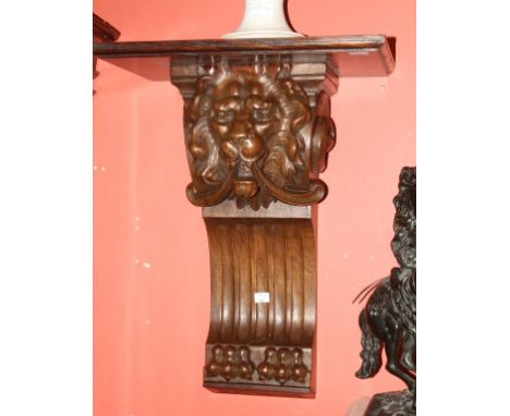 AN ATTRACTIVE PAIR OF LATE VICTORIAN CARVED WALNUT CORBEL WALL BRACKETS, each rectangular moulded shelf on a scroll corbel, w