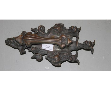 A HEAVY BRONZE DOOR KNOCKER, Edwardian, the top surmounted with three gargoyles and a grotesque mask below, 12" (30cm)h. (1) 