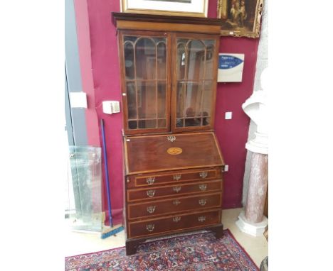 A GEORGIAN PERIOD INLAID AND CROSSBANDED MAHOGANY BUREAU BOOKCASE, the moulded cornice above two Gothic glazed doors, each wi