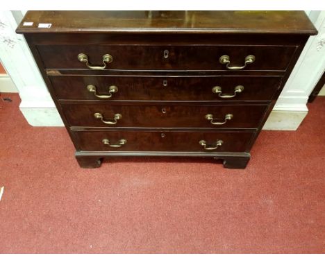 A GEORGE III PERIOD MAHOGANY AND CROSSBANDED CHEST, with four long drawers, under a moulded top, raised on bracket feet, the 