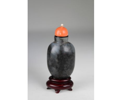 19th C. Chinese Black &amp; Grey Jade Snuff Bottle. In elongated form, the stone of mottled grey tones. Coral stopper with mo