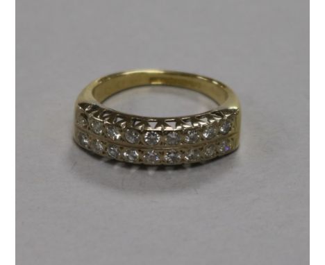 An 18ct gold and twin row diamond half hoop ring (one stone missing), size K.