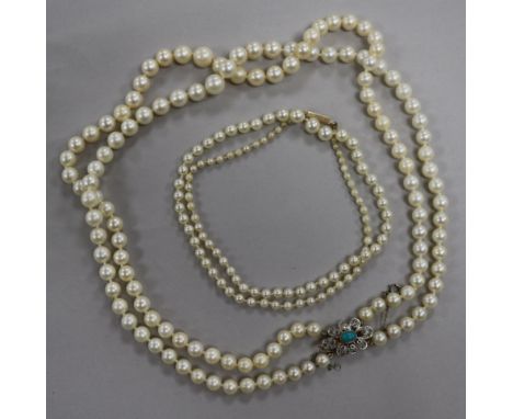 A double strand graduated cultured pearl necklace with gem set yellow metal clasp and a single strand cultured pearl necklace