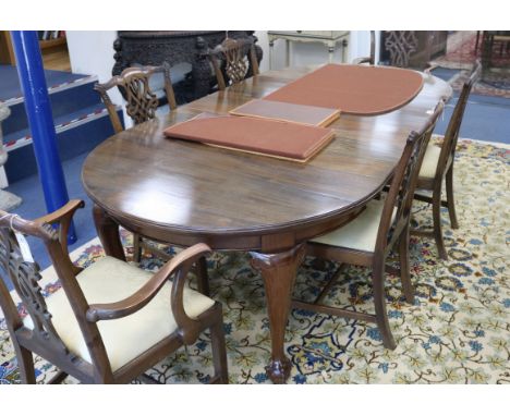 A Chippendale style circular mahogany extending dining table (three additional leaves) and a set of six Chippendale style car