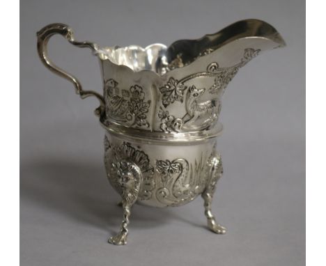 An Edwardian embossed silver cream jug, Williams Ltd, Birmingham, 1904, height 95mm.