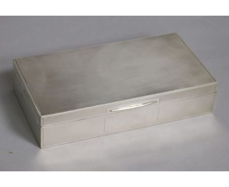 A George VI engine turned silver rectangular cigarette box, John Rose, Birmingham, 1946, 17.2cm.