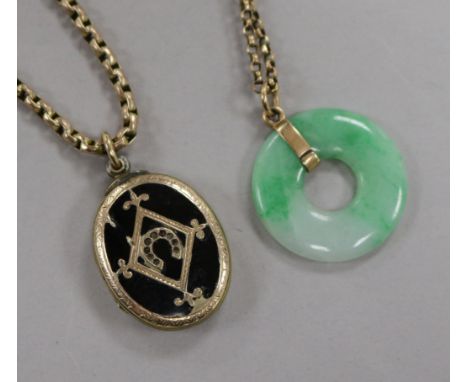 A Victorian gold overlaid and enamel locket with yellow metal chain and a jadeite disc pendant on a yellow metal chain.