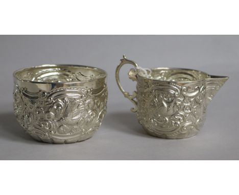 A late Victorian embossed silver cream jug and sugar bowl, Goldsmiths & Silversmiths Co, London, 1894, 4.5 oz.