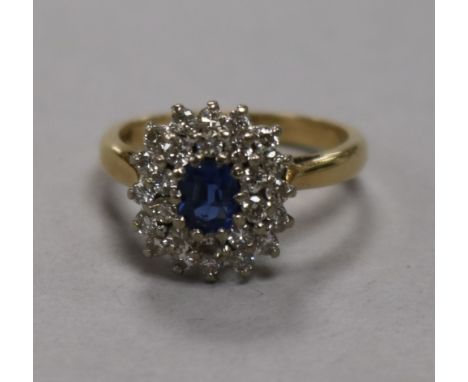 A sapphire and diamond cluster ring, 18ct gold setting, size K.