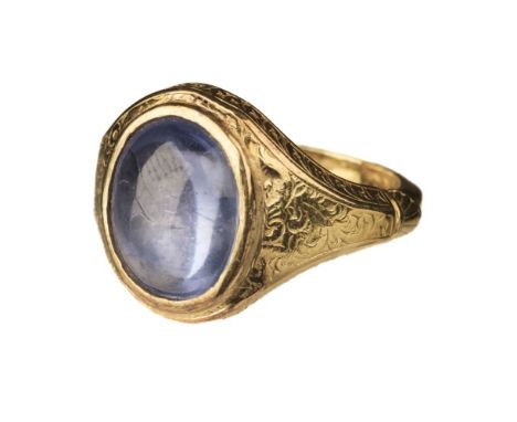 * Ring. An attractive yellow metal ring set, with a light blue polished cabachon, the mount engraved with foliate scrolls, O/