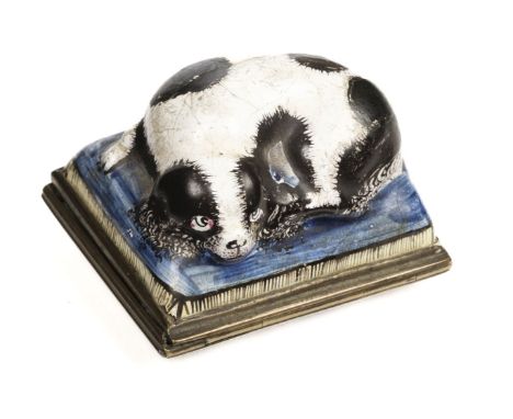 * Bilston Enamel. An 18th century Bilston enamel patch box, the hinged cover decorated with a recumbent spaniel on a blue cus