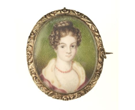 * Portrait Miniature. A Regency period portrait miniature of a young girl, painted on mother of pearl with a yellow metal fol