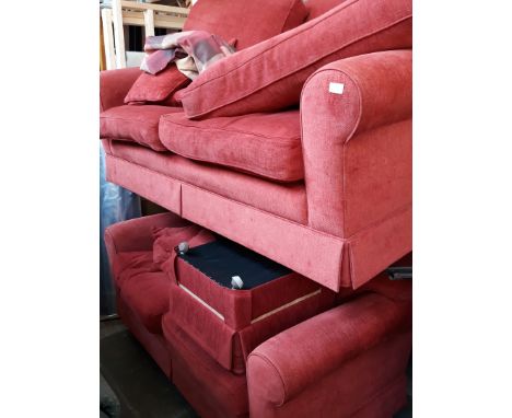 A 2 piece red cloth suite with matching pouffe 