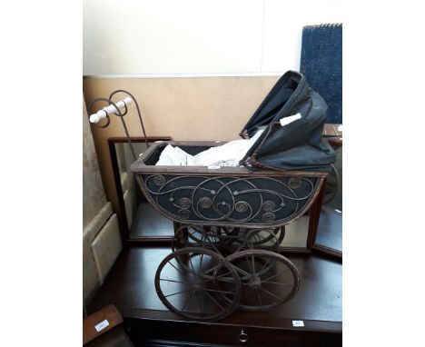 A vintage dolls pram and dolls 