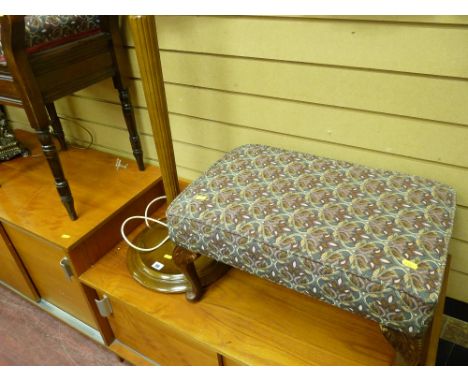 Neatly upholstered footstool and a standard lamp